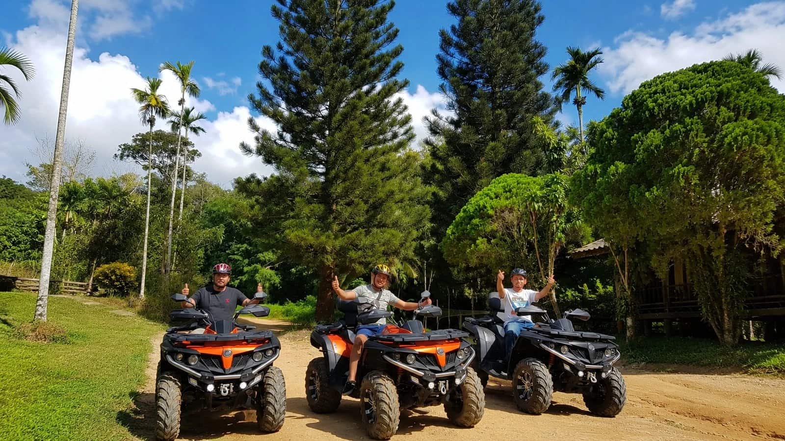 Three riders giving thumbs up on quads on a jungle track, Orange Wave, Koh Samui ATV tours